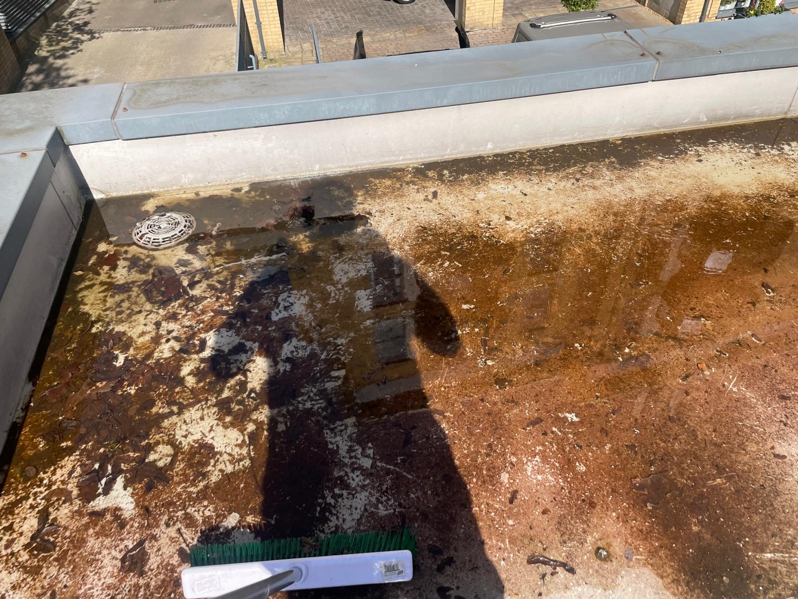 Dirty commercial flat roof before professional cleaning